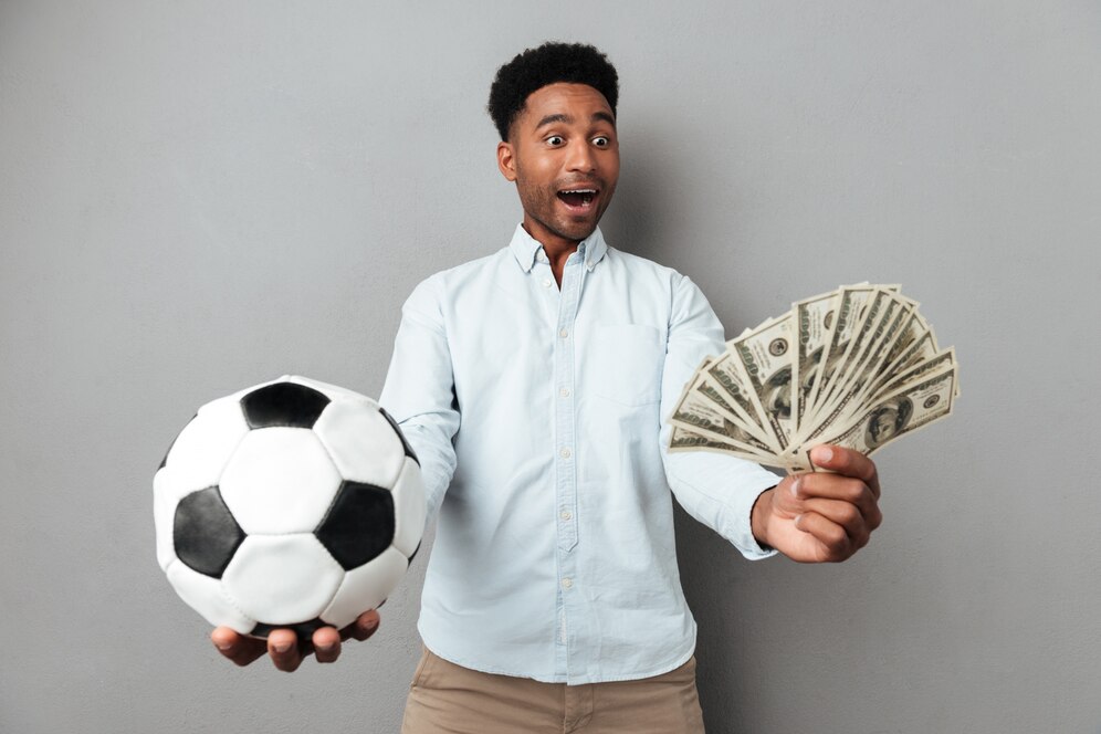 happy-smiling-african-man-showing-football-money-banknotes_171337-12877.jpg